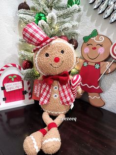 a teddy bear sitting on top of a table next to a christmas ornament