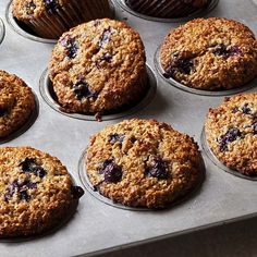 muffins with blueberries are sitting in a muffin tin, ready to be eaten