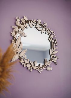 a mirror that is on the wall next to a plant