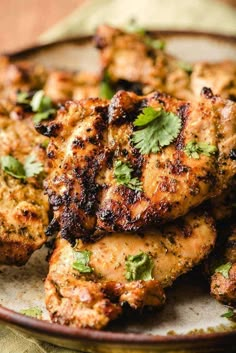 grilled chicken with cilantro and parsley on a plate