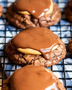 cookies with chocolate frosting and peanut butter on a cooling rack, ready to be eaten