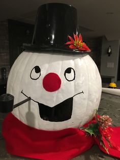 a large white pumpkin with a black top hat