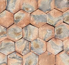 a close up view of some kind of hexagonal stone pattern that is brown and gray