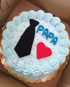 a birthday cake with the words papa and a tie on it, in a box