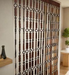 a room with a curtain made out of metal rings and chains hanging on the wall