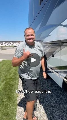 a man standing in front of a large motor home with the words look how easy it is