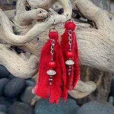 "These beautiful boho inspired earrings are hand-crafted using recycled sari silk and a variety of glass and seed beads.  They are very lightweight and the perfect addition for a casual day or fun night on the town Materials: Sari Silk/Glass, Wood & Metal Beads/Nickel Free Earwire Color: Red Measurements: Drop length approx. 2 3/4\"/Tassel 2\" Weight : 1 gram/.07 oz. (individual earring) Designer: Norma Patridis *Each set of earrings comes boxed ready for gifting* Please note that color may slig Bohemian Latkans Earrings For Beach, Artisan Red Beaded Earrings For Festival, Bohemian Beaded Earrings With Latkans For Beach, Traditional Beaded Tassel Earrings For Beach, Bohemian Beaded Latkans Earrings For Beach, Bohemian Beaded Latkan Earrings For Beach, Bohemian Tassel Earrings With Dangling Beads For Festive Occasions, Bohemian Beaded Earrings With Latkans For Summer, Red Handwoven Beaded Earrings For Festival