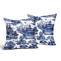 two blue and white pillows with pagodas on them