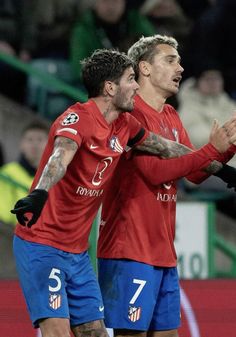 two soccer players are congratulating each other