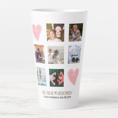 a white coffee cup with pink hearts and photos on the inside, in front of a marble background