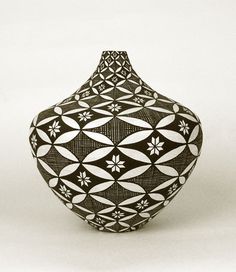 a black and white vase sitting on top of a table