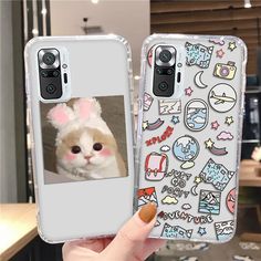 a person holding up a phone case with an image of a cat in bunny ears