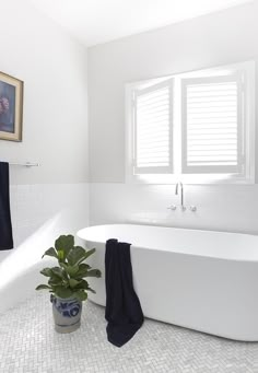 a white bath tub sitting next to a window