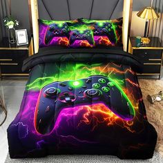 a bed covered in a comforter and pillows with a game controller on the cover