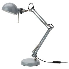 a gray desk lamp with a white background