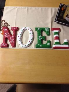 the word noel spelled out with christmas decorations