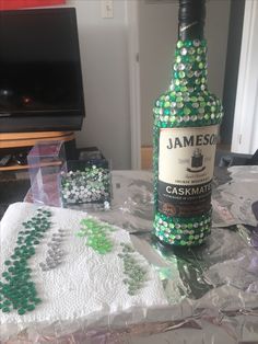 a bottle of jameson is sitting on the table next to some beads and other items