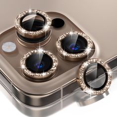 an iphone with three camera lens covers on it's front and back sides, surrounded by diamonds