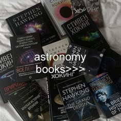 there are many books on the bed together with words above them that read astronomy books > >