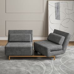 a chair and ottoman in a living room with a rug on the floor next to it