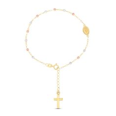 This marvelous and meaningful rosary bracelet is fashioned in 14K yellow gold and features a dangling cross charm. High-polish beads crafted in 14K yellow, 14K white and 14K rose gold add a beautiful tri-color contrast. The bracelet measures 6.5 inches with a 1 inch extender and secures with a spring ring clasp. Jesus Bracelet, Beaded Rosary, Rosary Bracelet, Jewelry Essentials, Yellow Gold Bracelet, Oval Cut Diamond, Cross Charms, Religious Jewelry, Color Contrast