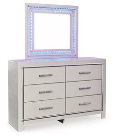 a white dresser with a lighted mirror on top