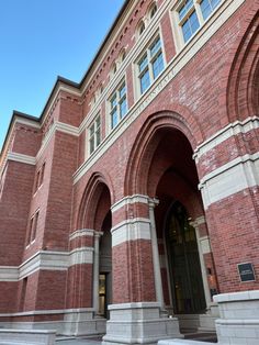 an old brick building with arches and pillars