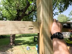 a man using a drill to attach a wooden fence