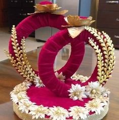 an elaborately decorated chair with flowers and leaves on the seat is sitting on a wooden table