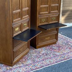 two large wooden cabinets sitting next to each other on top of a carpeted floor