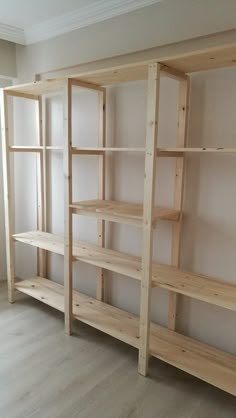 an empty room with wooden shelves in it