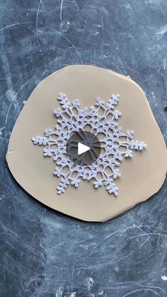 a paper snowflake is shown on a table