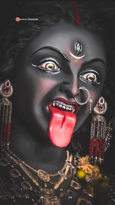 the face of a woman with her tongue out and eyes open, is painted in black