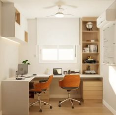 two orange chairs sitting in front of a desk