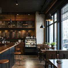 the interior of a restaurant with wooden tables and stools in front of large windows