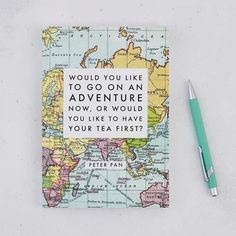 a notebook with a quote on the cover and a pen next to it that says would you like to go on an adventure now, or would you like to have your tea first?