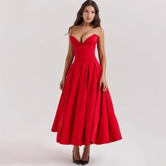 a woman is wearing a red dress and heels