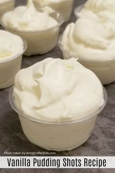 several cups filled with whipped cream on top of a table