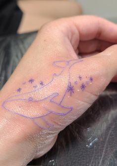 a person's hand with purple ink and stars on the left side of their arm