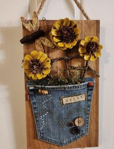 a denim pocket with flowers in it hanging on a wall