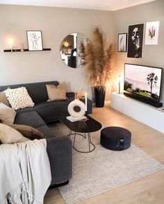 a living room filled with furniture and pictures on the wall