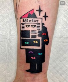 a person with a tattoo on their leg that reads bad news and is looking at a computer screen