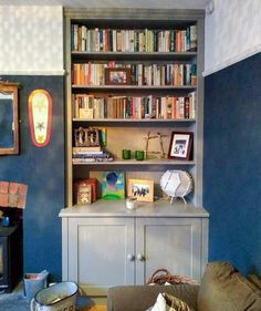 a living room filled with furniture and bookshelves