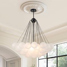 a chandelier hanging from the ceiling in a dining room