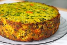 a quiche on a glass plate sitting on a table