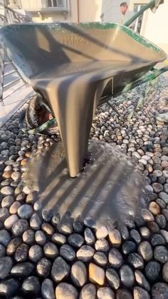 there is a fountain with rocks on the ground