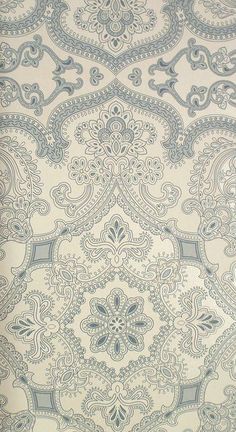 a blue and white wallpaper with an ornate design