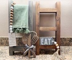 a wooden chair sitting on top of a counter next to a sign that says eat