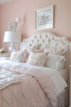 a bedroom with pink walls and white bedding