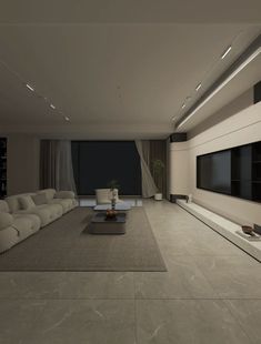 a large living room with white couches and a flat screen tv mounted on the wall